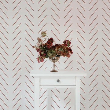 Minimal bedroom interior with white and pink color palette and modern herringbone design removable wallpaper feature wall